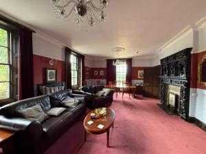 a living room with a couch and a fireplace at Coundon Lodge Coventry in Coventry