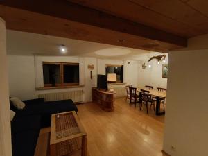 a living room with a couch and a table at Krumm und Schief Appartments in Brunau