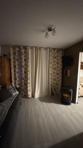 a living room with a couch and a window at LE GL'ASSIE in Saint-Gervais-les-Bains