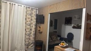 a living room with a mirror and a couch at LE GL'ASSIE in Saint-Gervais-les-Bains