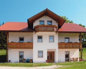 uma grande casa branca com um telhado vermelho em Haidberg-Hof em Sankt Englmar