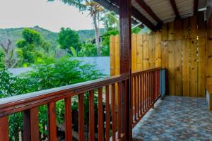 a wooden balcony of a house with a view at T3 Duplex - Tsimkoura in Chirongui