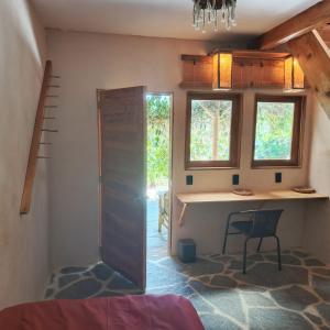 a room with a desk and a chair and windows at Casa Zapote in Sololá