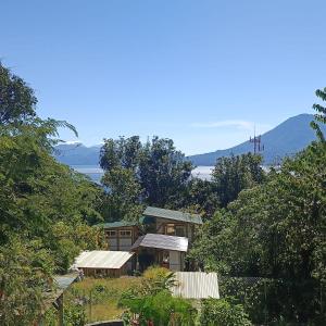a house on the side of a hill with trees at Casa Zapote in Sololá