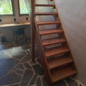 a wooden staircase in a room with a desk at Casa Zapote in Sololá