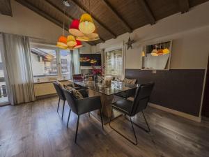 a dining room with a table and chairs at Central & Elegant Apartments,partially with Fireplace, by Zermatt Rental in Zermatt