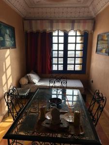 a living room with a table and a couch at arganier solitaire in Souira Guedima