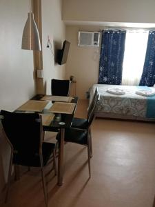 a room with a table and chairs and a bed at Peaceful and Convenient Condo - Avida Tower in Cagayan de Oro +28 photos