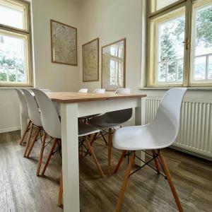 a dining room with a table and chairs at Resident Rebels in Železná Ruda +8 photos