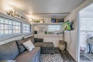 a living room with a couch in a tiny house at Mountain Top Cabin with a View - Bear Cabin in Ruidoso