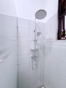 a shower with a shower head in a bathroom at Five-Eight Residences in Jinja +85 photos