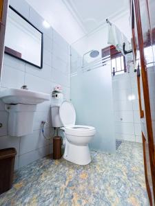 a bathroom with a toilet and a sink at Five-Eight Residences in Jinja