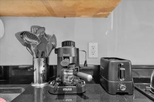 a kitchen counter with a coffee maker on the counter at Gramercy Apartment - 3BR 2BA Modern Central in New York