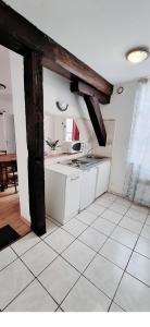 シャルトルにあるApartment Antan - Centerの白いタイルフロアのキッチン(白いキャビネット付)