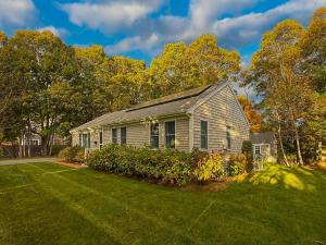 een huis met een tuin met een grasveld bij Cape Cod Family Getaway Hot Tub Firepit in West Hyannisport