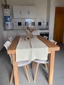 Hogar في ريو جاليجوس: مطبخ مع طاولة خشبية عليها مزهرية