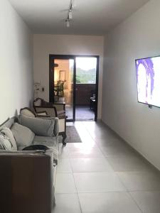 a living room with a couch and a flat screen tv at HABITACIÓN en VILLA ALLENDE, north green in Villa Allende