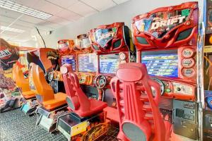 a group of pinball machines in a room at 2BR Fireworks View with Pool & Spa 5 Minutes to Disney in Vineland