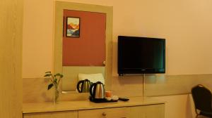 a flat screen tv sitting on top of a dresser at Hotel Summersands Al Wadi Al kabir in Muscat +15 photos