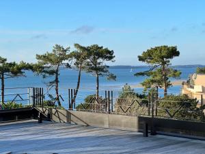 a boardwalk with a view of the ocean at Yatt Hotel in Arcachon