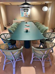 a conference room with a green table and chairs at Yatt Hotel in Arcachon +23 photos