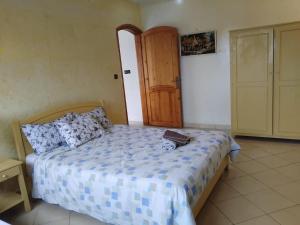 a bedroom with a bed and a door with a suitcase on it at Modern villa with pool in Mirleft +9 photos