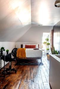 a bedroom with a bed on top of a wooden floor at Parking Free - Short North - Convention - Pets in Columbus