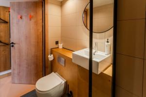a bathroom with a white toilet and a sink at easyHotel Valencia Ciutat Vella in Valencia