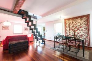 a living room with a staircase leading to a bedroom at Sunflower Apartment with private terrace and lift in Genova
