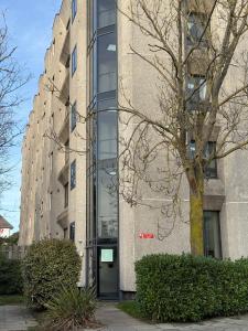 a building with a tree in front of it at Modern Refurbished Apt in Stevenage Town Centre in Stevenage