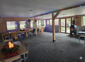 a restaurant with tables and chairs and a wood stove at Cornu Complex Mem in Campina
