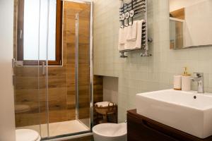 a bathroom with a shower and a toilet and a sink at ROOMITO apartments in Naples +41 photos
