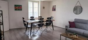 a living room with a table and chairs and a couch at La Ville Haute in Chauvigny