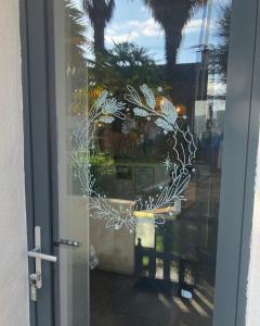 a glass door with a view of a patio at Maison de pêcheur proche du bourg in Ile aux Moines