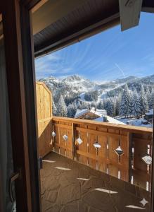 a balcony with a view of snow covered mountains at Almhaus Bachmann in Sonnenalpe Nassfeld