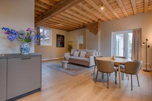 a kitchen and living room with a table and chairs at House of De Swaen Apartments in Breda