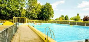 a large swimming pool with people in the water at 3 bedrooms Family House till 6 p Near Amsterdam & Sea in Opmeer