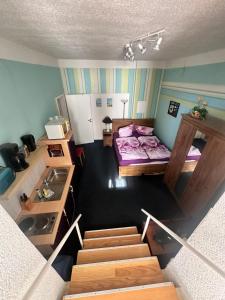 a room with two bunk beds and a staircase at Ostsee Welle in Rostock