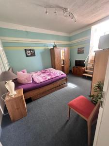 a bedroom with a bed and a stair case at Ostsee Welle in Rostock
