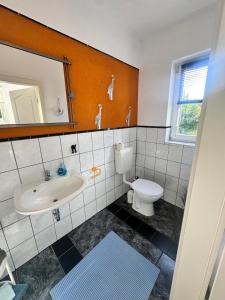 a bathroom with a sink and a toilet at Ostsee Welle in Rostock
