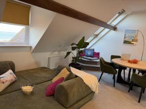 a living room with a couch and a table at Coastal Nest in Margate