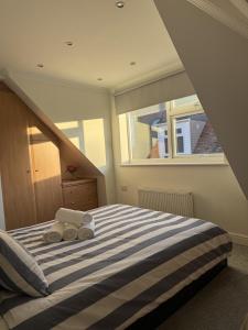 a bedroom with a bed with two towels on it at Coastal Nest in Margate