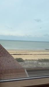 a view of the ocean from a window at Coastal Nest in Margate