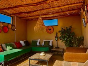 a living room with a couch and a table at Riad Dar El Hana in Taroudant