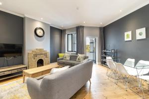 een woonkamer met een bank en een open haard bij Central Green Point Apartment in Kaapstad