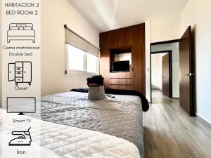 una camera da letto con un letto e una TV di Increíble departamento en Juriquilla Qro a Juriquilla