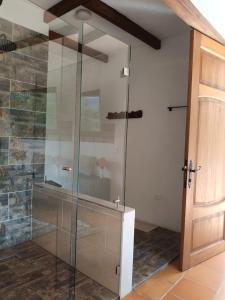 a shower in a bathroom with a glass door at Hotel Pliosaurio Campestre in Villa de Leyva +149 photos