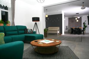 a living room with a blue couch and a table at Zacisze Teremiski in Białowieża