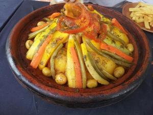 a bowl of food with vegetables on a table at Gîte flilou in Midelt