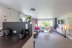 a room with a kitchen and a living room at Jonkerstee 21 - Ouddorp in Ouddorp
